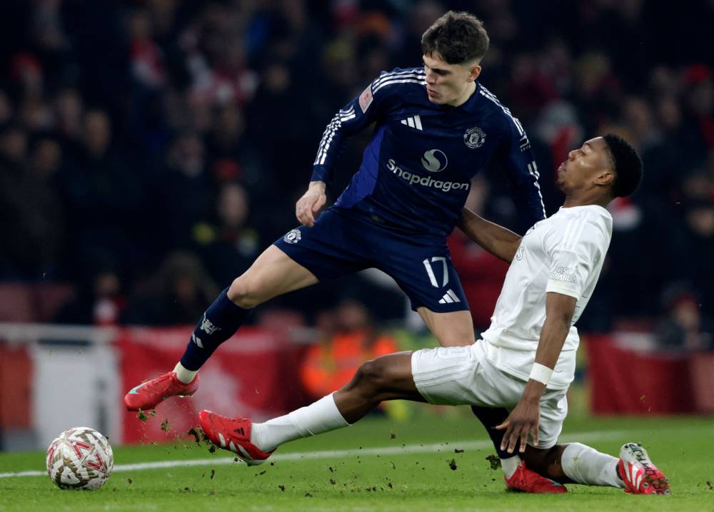 Arsenal's English midfielder Myles Lewis-Skelly (R) vies with Manchester United's Argentinian midfielder Alejandro Garnacho during the English FA Cup third round football match between Arsenal and Manchester United at the Emirates Stadium in London on January 12, 2025. (Photo by Ian Kington/IKIMAGES/AFP)