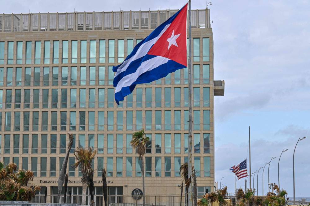 A Cuban and a US flag are seen near the US Embassy to apply for a visa in Havana on January 15, 2025. (Photo by ADALBERTO ROQUE/AFP)