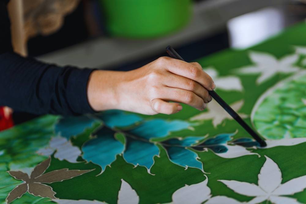 Innovations in batik production have revolutionised the craft, making it affordable while maintaining quality. Photo: Edited via Canva