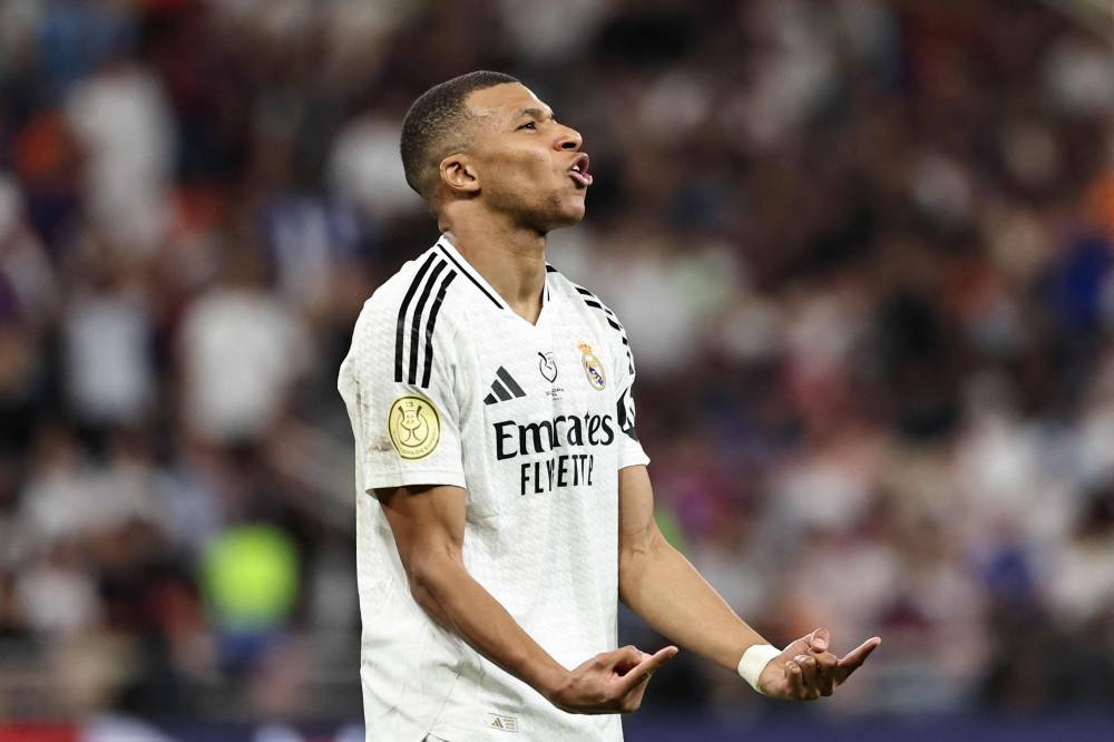 Real Madrid's French forward #9 Kylian Mbappe reacts during the Spanish Super Cup final football match between Real Madrid and Barcelona at the King Abdullah Sport City in Jeddah on January 12, 2025. (Photo by FADEL SENNA / AFP)