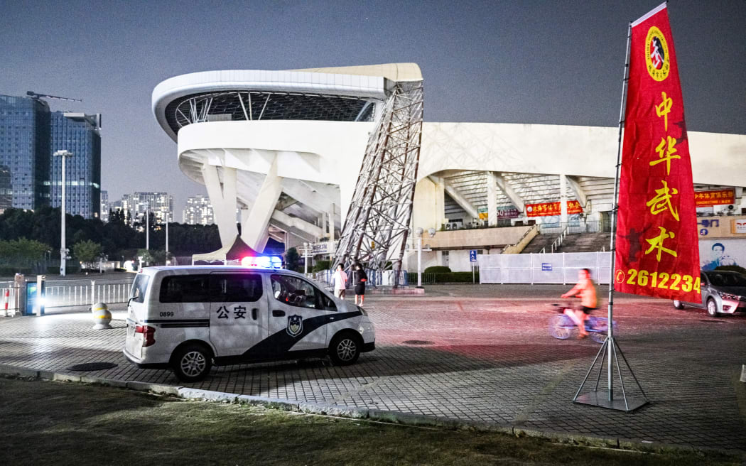 A police car at the Zhuhai Sports Centre, a day after a car rammed through the site killing dozens in Zhuhai, in south China's Guangdong province on Nov 12. Photo by Hector Retamal/AFP
