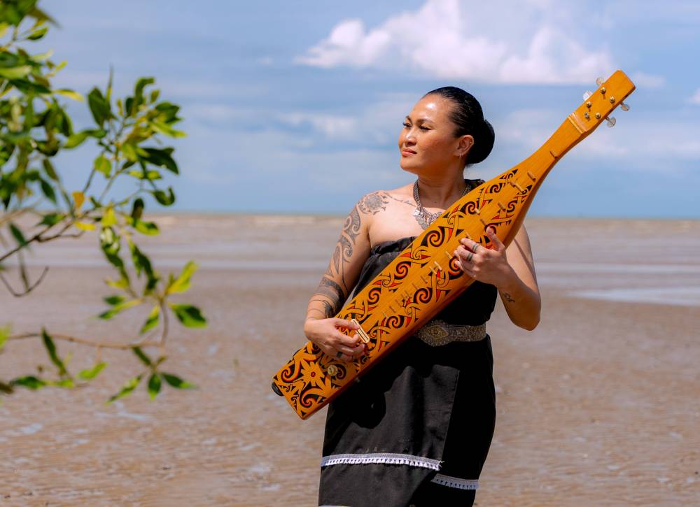 Munirih said her passion for the sape was fuelled by both curiosity and a desire to challenge herself by mastering another art form. Photo by Bernama
