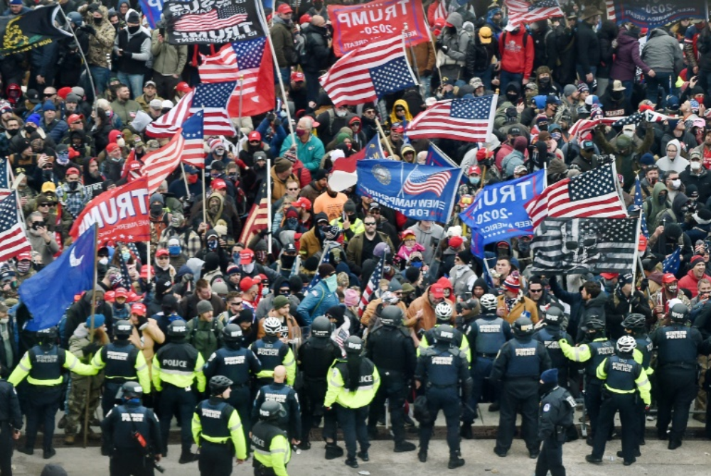 Trump supporters clash with police as they storm the US Capitol in Washington on January 6, 2021
Photo by AFP