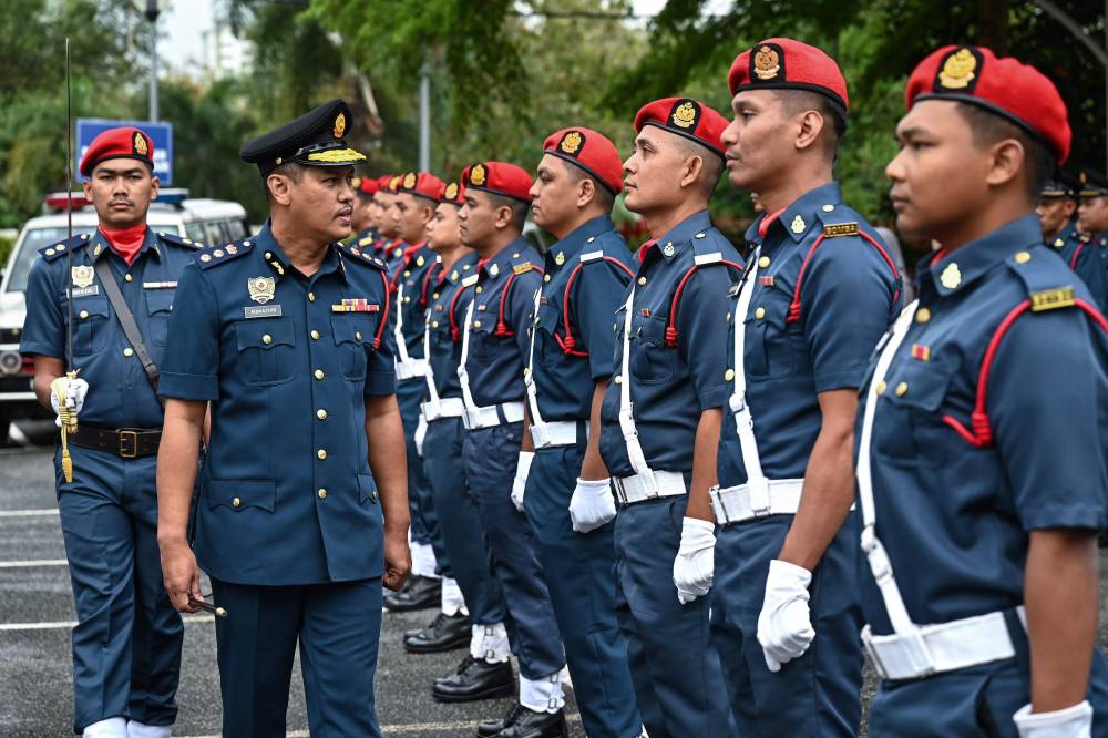 Terengganu Fire and Rescue Department director Nor Mahathir Muhamad inspects the parade during the department's state Annual Parade 2025, today. - Photo by Bernama