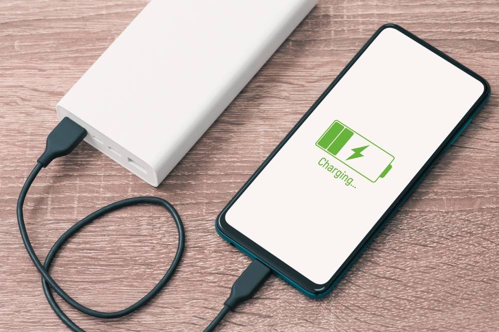 While power banks offer great convenience, their lithium batteries can become fire hazards if not handled with care. Photo: Edited via Canva