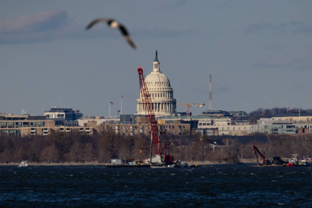 Cranes work to recover American Eagle Flight 5342 from the Potomac River on Jan 29, 2025 in Arlington, Virginia. - (Photo by Anna Rose Layden / AFP)
