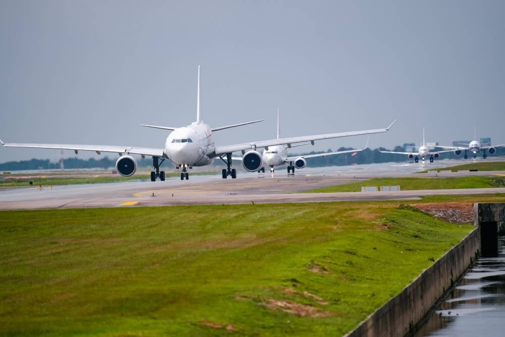 The plane spotters' hands are always poised, ready to press the shutter button to capture the arrival or departure of an aircraft-whether for personal collections or to share with aviation enthusiasts worldwide. Photo by Bernama