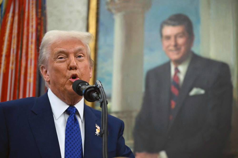 US President Donald Trump speaks before swearing in Tulsi Gabbard as Director of National Intelligence (DNI) in the Oval Office of the White House in Washington, DC, on February 11, 2025. (Photo by ANDREW CABALLERO-REYNOLDS/AFP)