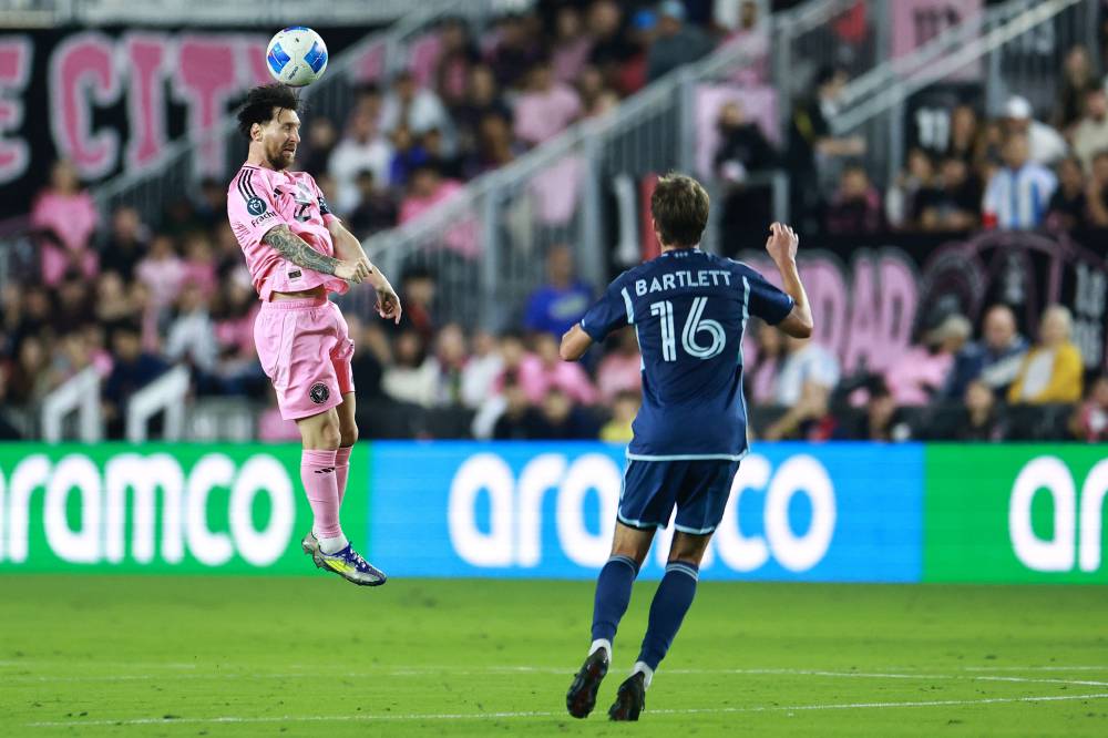 Lionel Messi of Inter Miami wins a header in front of Jacob Bartlett of Sporting Kansas City during the first half of a 2025 Concacaf Champions Cup second leg match between Sporting Kansas City and Inter Miami at Chase Stadium on February 25, 2025 in Fort Lauderdale, Florida. - Photo by AFP