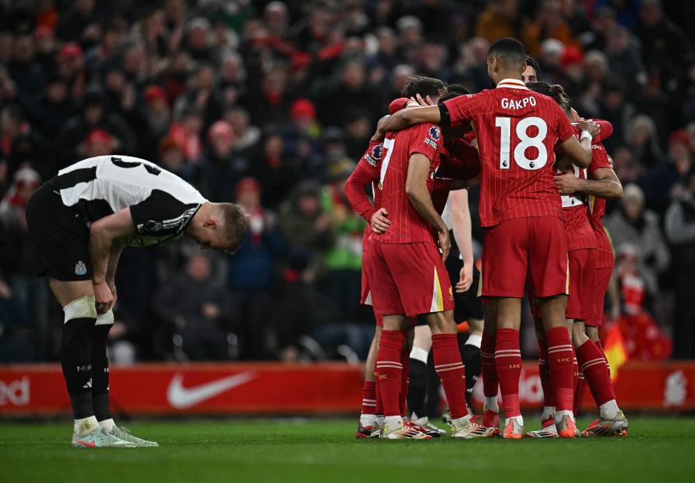 Liverpool's Argentinian midfielder Alexis Mac Allister is mobbed by teammates after scoring the team's second goal during the English Premier League football match between Liverpool and Newcastle United at Anfield in Liverpool, north west England on February 26, 2025. (Photo by Paul ELLIS / AFP) / RESTRICTED TO EDITORIAL USE. No use with unauthorized audio, video, data, fixture lists, club/league logos or 'live' services. Online in-match use limited to 120 images. An additional 40 images may be used in extra time. No video emulation. Social media in-match use limited to 120 images. An additional 40 images may be used in extra time. No use in betting publications, games or single club/league/player publications. /
