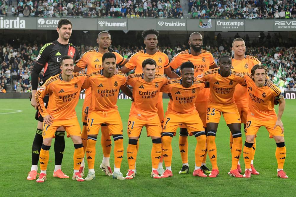Real Madrid players pose for a team photo before the Spanish league footbal match between Real Betis and Real Madrid CF at Benito Villamarin Stadium in Seville on March 1, 2025. (Photo by CRISTINA QUICLER / AFP)