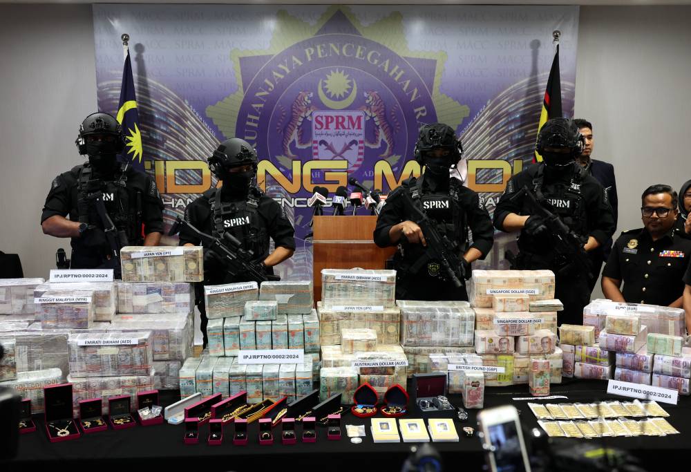 The cash and gold were recovered in raids conducted at the residences of the four officers and three other premises believed to be “safe houses”. - Bernama photo
