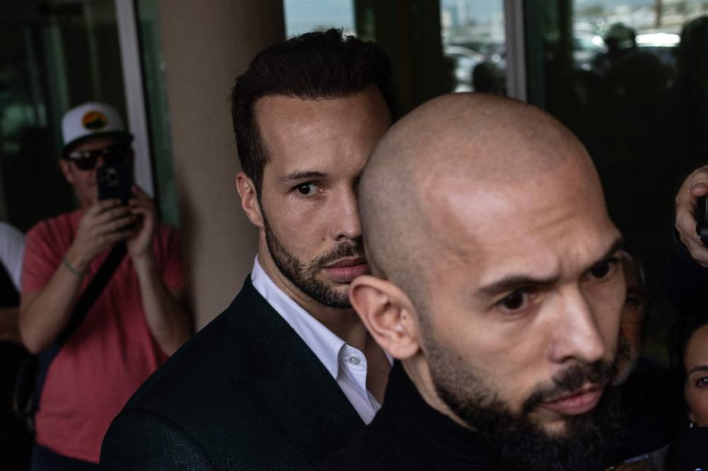 Andrew Tate (R) and Tristan Tate (L) arrive in the United States after a travel ban on them was lifted, at the Fort Lauderdale-Hollywood International Airport on February 27, 2025 in Fort Lauderdale, Florida. - AFP photo