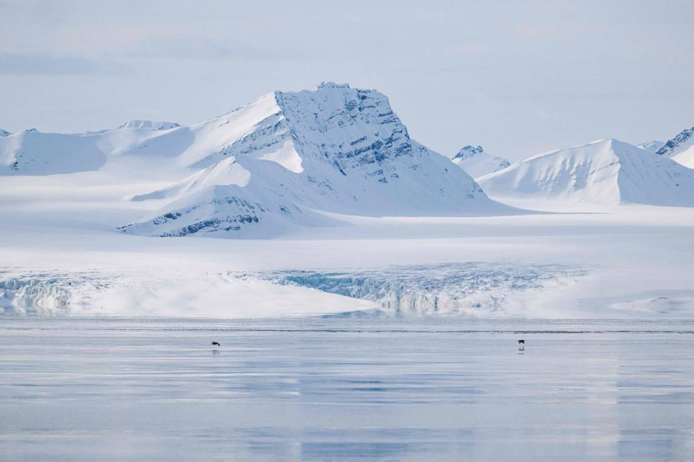 This file photo taken on May 3, 2022, shows a view of the Nansenbreen glacier in the Borebukta Bay, located at the northwestern side of Isfjorden, in Svalbard Archipelago, northern Norway. (Photo by Jonathan NACKSTRAND / AFP)