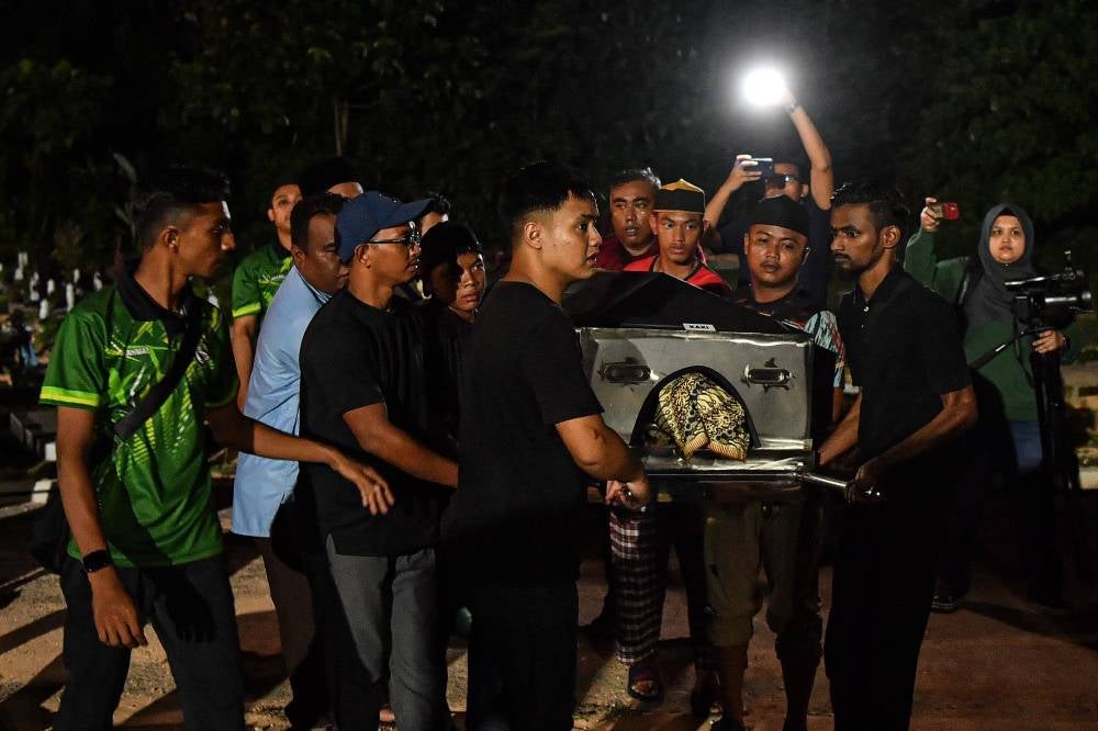 People carrying the body of the late Aisar Azim Abdullah for burial at the Maqbarah Salimah Muslim cemetery in Taman Zaitun Indah, today. - Photo by Bernama