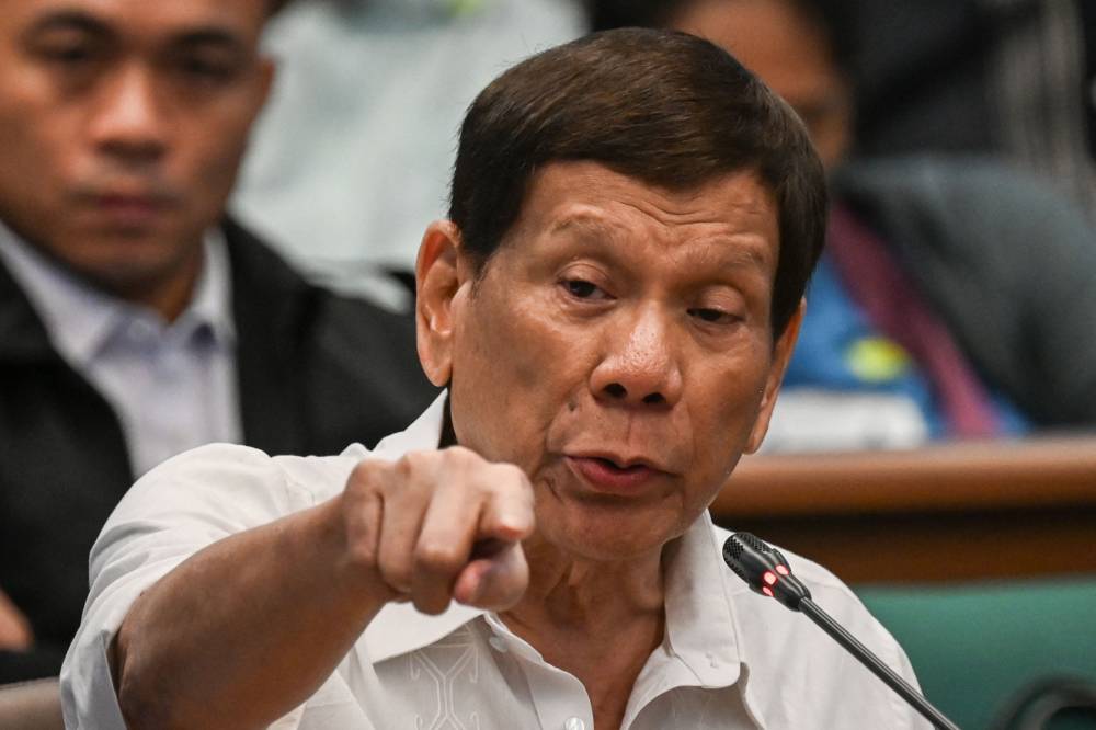 Former Philippine president Rodrigo Duterte gestures as he attends a senate probe on the drug war during his administration, in Manila on October 28, 2024. (Photo by JAM STA ROSA / AFP)