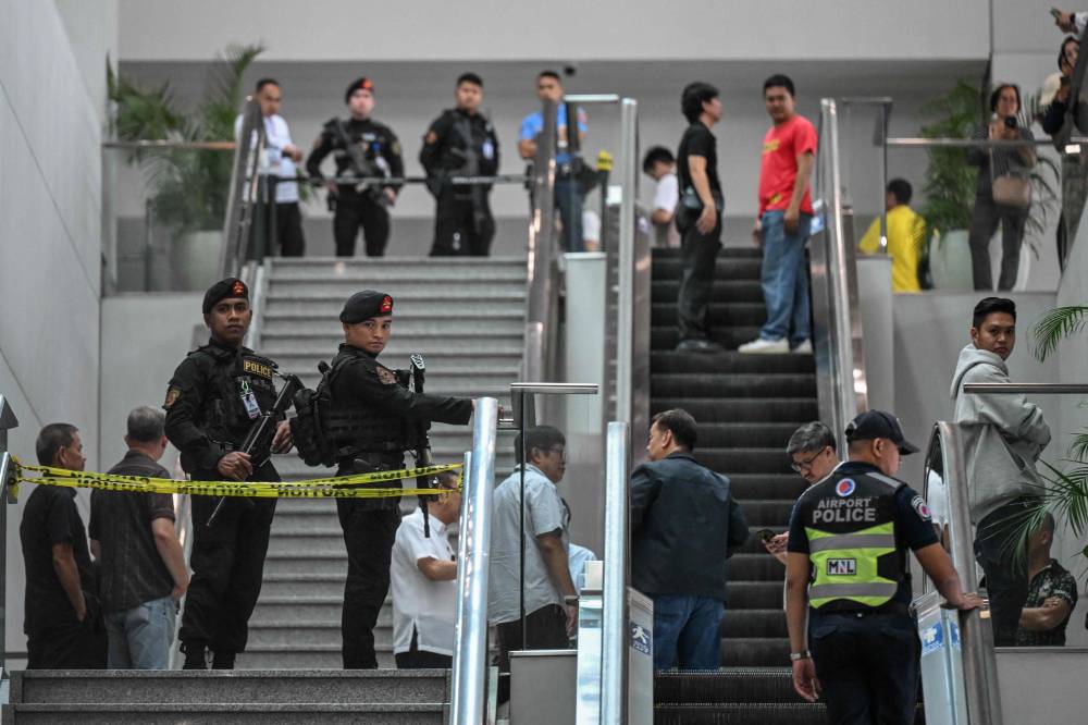 Policemen gather as they wait for the arrival of former Philippine president Rodrigo Duterte at Ninoy Aquino International Airport in Pasay, metro Manila on March 11, 2025. (Photo by Jam STA ROSA / AFP)