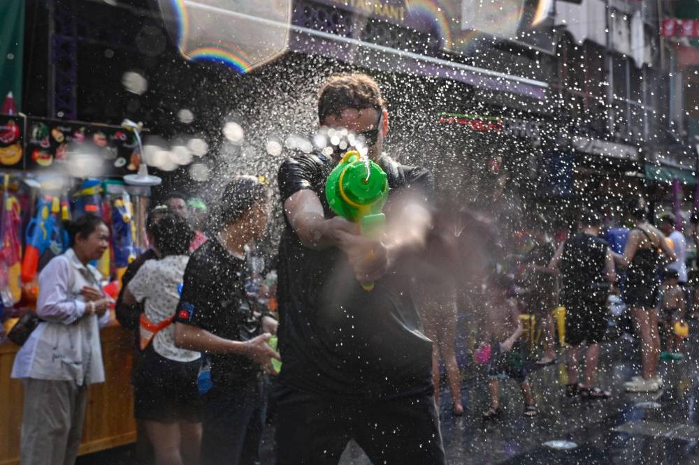 Revellers take part in mass water fights on the eve of Songkran, or Thai New Year on Khao San Road in Bangkok last year. Photo by Lillian Suwanrumpha/AFP FILE PIX