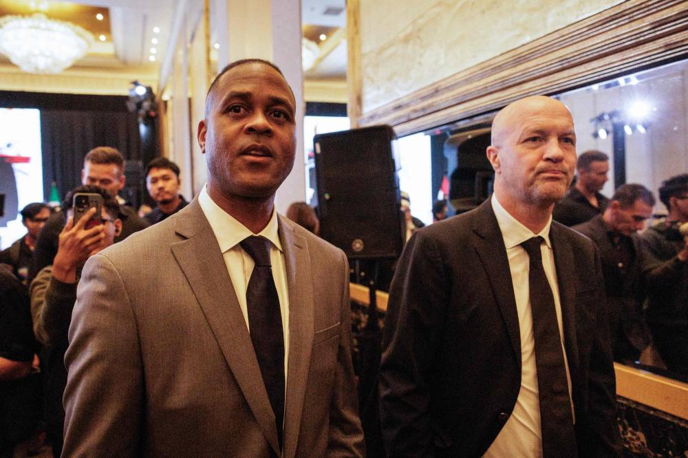 Netherlands' Jordi Cruyff (R), newly-appointed technical advisor of the Indonesian Football Association (PSSI), and Netherlands' Patrick Kluivert, head coach of Indonesia's men's national football team, leave after a press conference in Jakarta on March 11, 2025. (Photo by Yasuyoshi CHIBA / AFP)