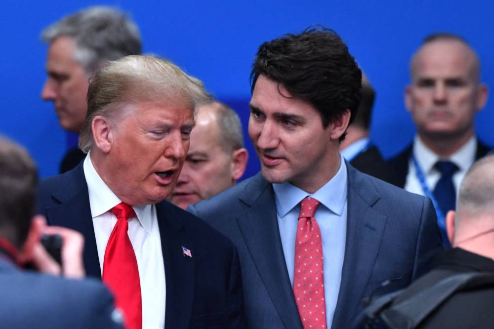 FILE PIX - US President Donald Trump (L) talks with Canada's Prime Minister Justin Trudeau during the plenary session of the NATO summit at the Grove hotel in Watford, northeast of London on Dec 4, 2019. (Photo by Nicholas Kamm/AFP)