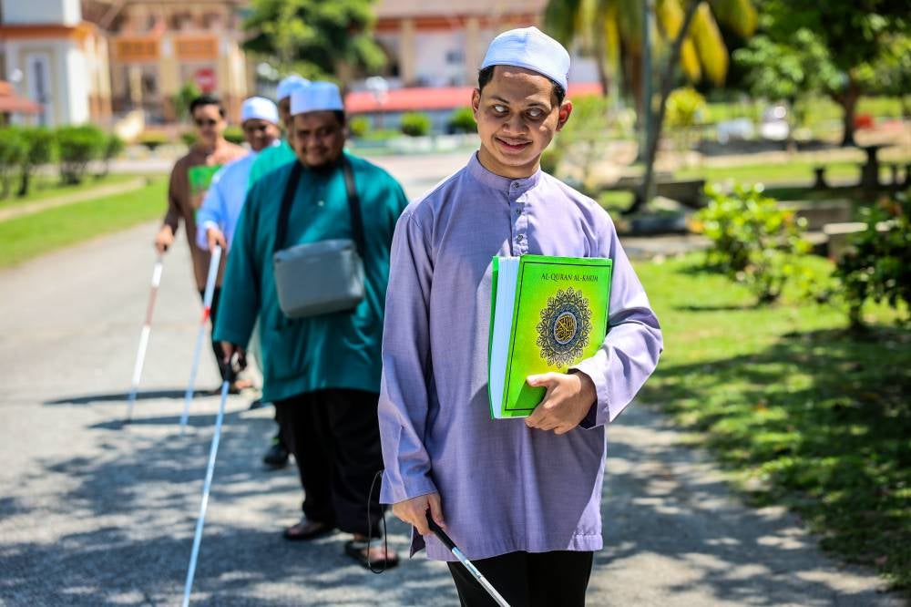Muhammad Rifaa Haiduri, 22, along with several visually impaired (PwD) friends, are students of the Basic Certificate of Tahfiz and Diploma in Tahfiz Al-Quran and Qiraat. Photo by Bernama