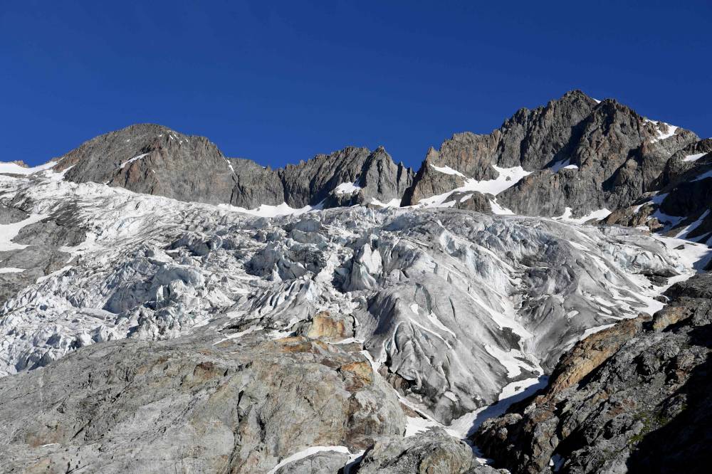 The accelerated melting of glaciers due to global warming is leading to the creation of new lakes, some of which can threaten human lives downstream, particularly in the Alps, where the authorities are trying to contain the risk. (Photo by JEAN-PIERRE CLATOT / AFP)