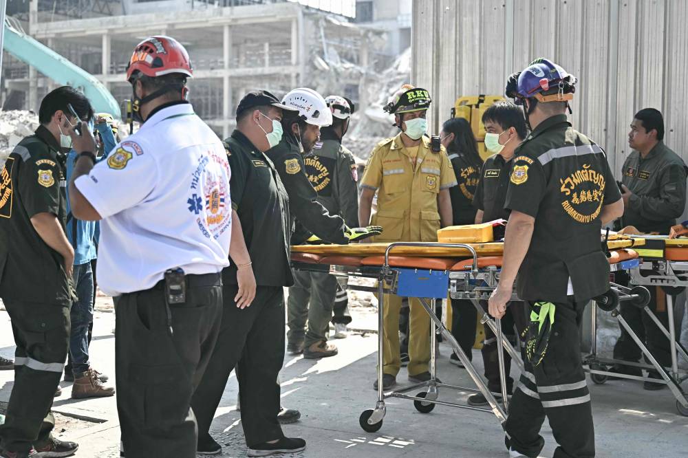 Rescuers prepare a stretcher to transfer injured people at a construction site where a building collapsed in Bangkok after an earthquake. Photo by Lillian Suwanrumpha/AFP