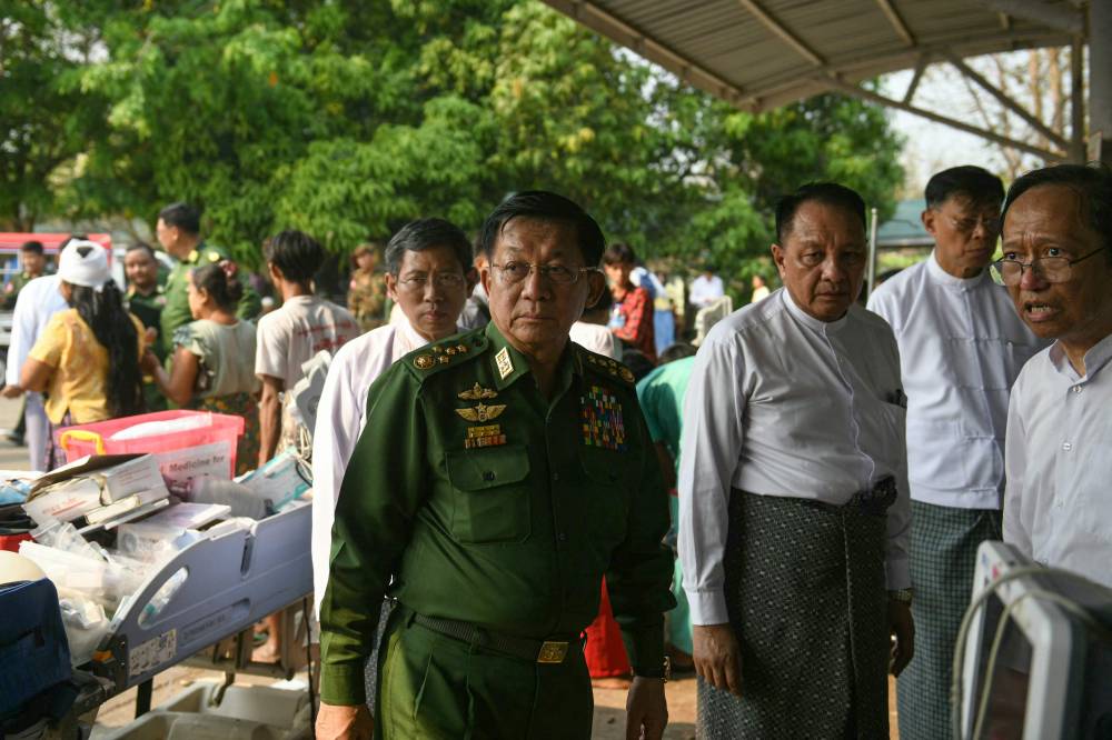 Myanmar's military chief Min Aung Hlaing (C) arrives to meet earthquake survivors gathered in the compound of a hospital in Naypyidaw on March 28, 2025, after an earthquake in central Myanmar. A powerful earthquake rocked central Myanmar on March 28, buckling roads in capital Naypyidaw, damaging buildings and forcing people to flee into the streets in neighbouring Thailand.
Photo by AFP