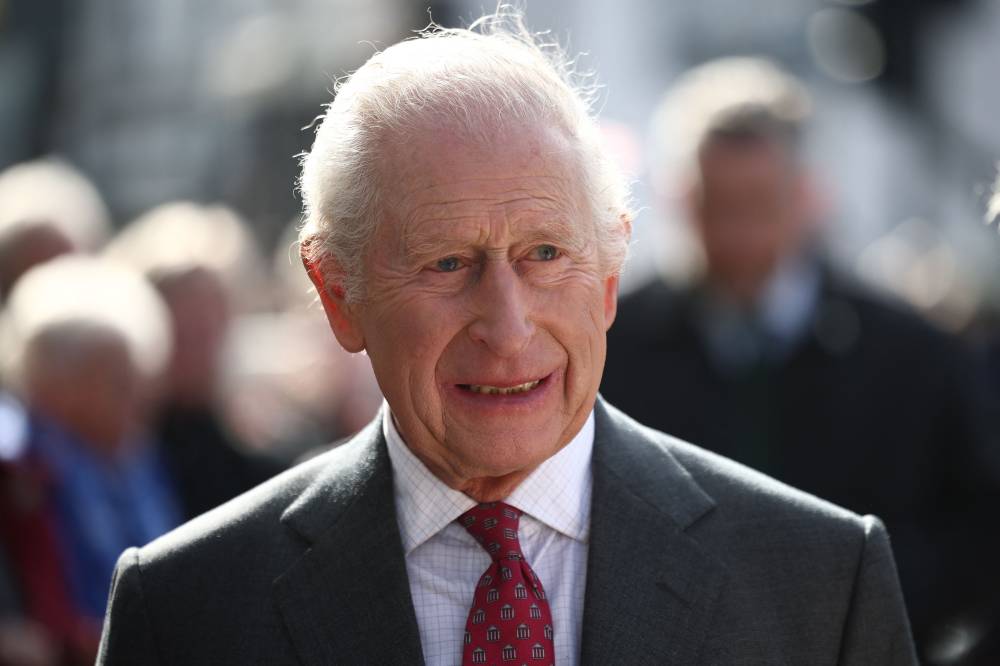 Britain's King Charles III meets well-wishers as he arrives with Britain's Queen Camilla to visit the Roe Valley Arts and Cultural Centre, in Limavady, on March 20, 2025, during a three-day trip to Northern Ireland. Britain's King Charles III on March 27, 2025, was forced to cancel his appointments after suffering "side effects" following his cancer treatment, Buckingham Palace said in a statement. (Photo by HENRY NICHOLLS / POOL / AFP)