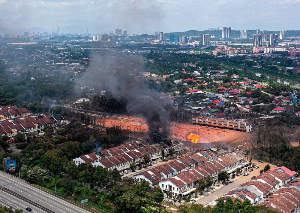 The scene at Putra Heights, Subang Jaya, resembled a war zone following a gas pipeline fire that broke out at 8.10am yesterday. Photo by Bernama