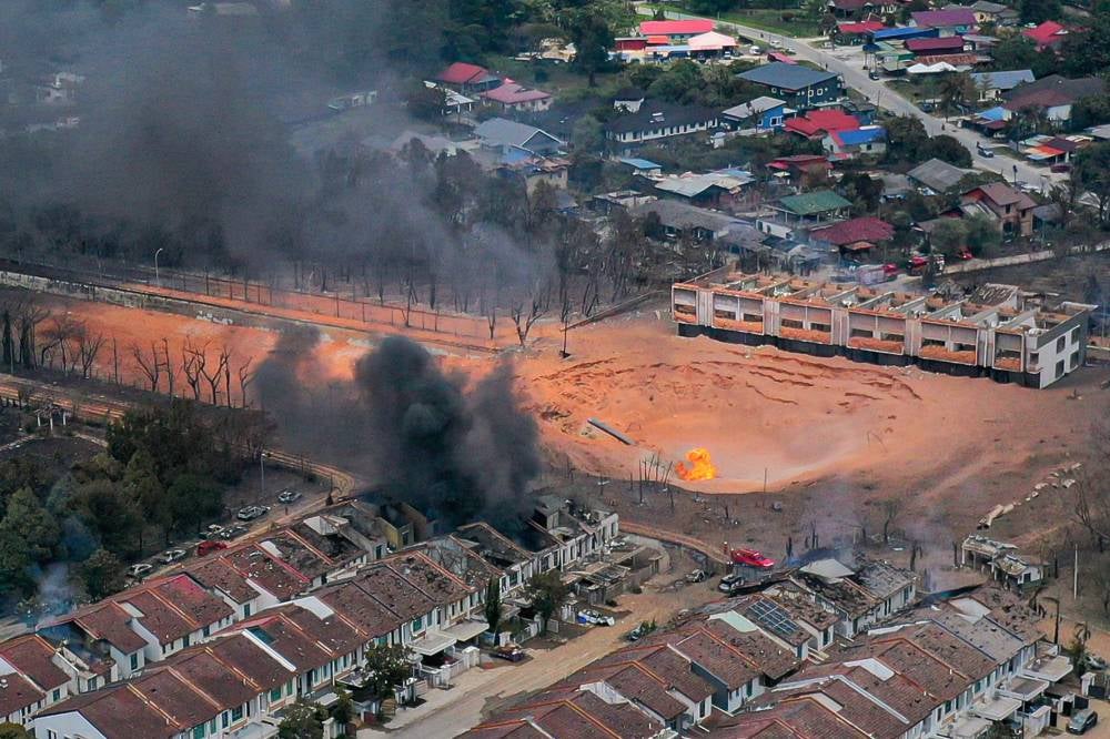 The scene at Putra Heights, Subang Jaya, resembled a war zone following a gas pipeline fire that broke out at 8.10am yesterday. Photo by Bernama