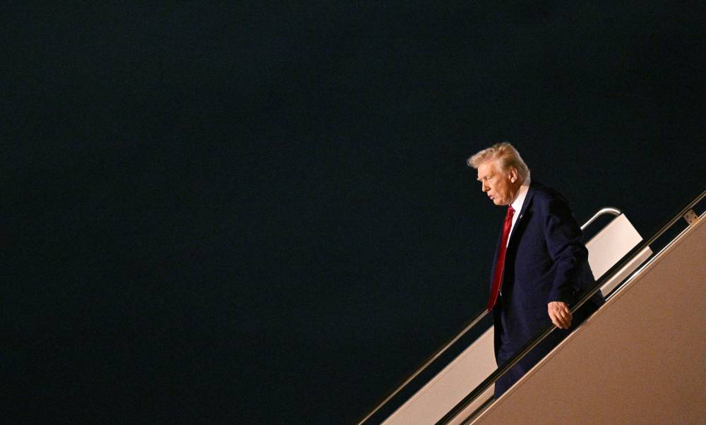US President Donald Trump steps off Air Force One upon arrival at Palm Beach International Airport in West Palm Beach, Florida on April 3, 2025.- (Photo by MANDEL NGAN / AFP)