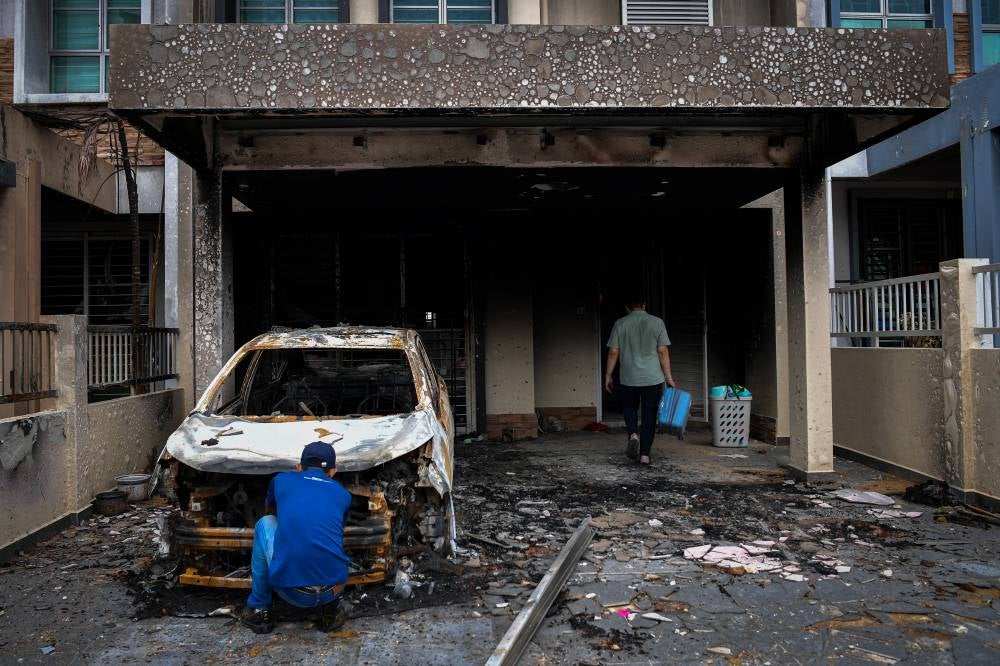 The scene at Jalan Putra Harmoni, Putra Heights, resembled a ghost town, with homes and vehicles left in ruins following a gas pipeline fire. Photo by Bernama
