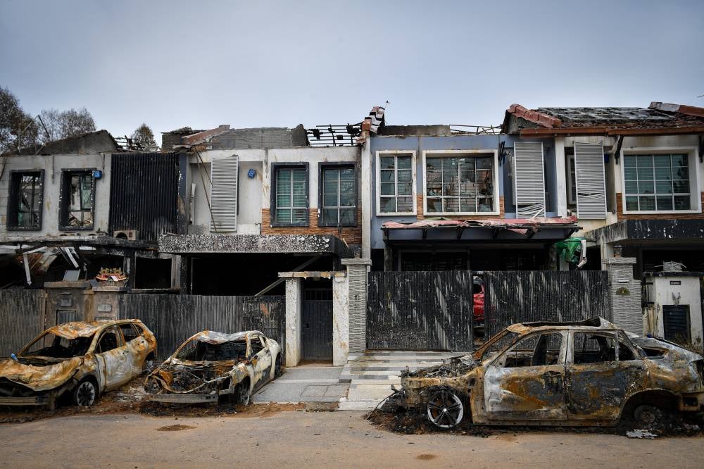 The scene at Jalan Putra Harmoni, Putra Heights, resembled a ghost town, with homes and vehicles left in ruins following a gas pipeline fire. Photo by Bernama