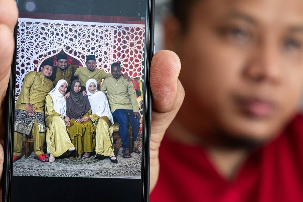 The photo was taken the previous weekend, ahead of Hari Raya Aidilfitri and it was the first time the family had arranged a studio session. Photo by Bernama