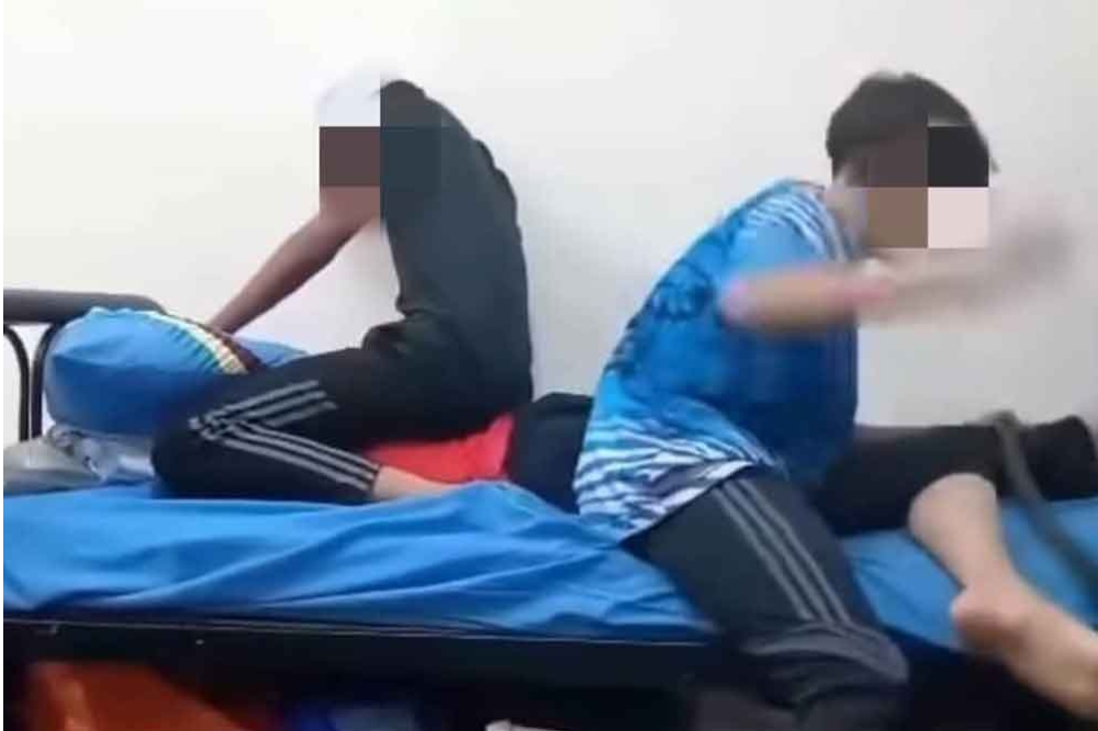 A screenshot from a viral video showing two teenagers allegedly hitting a student, believed to have occurred at an MRSM in Penang.