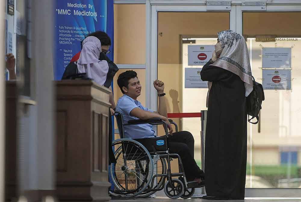 Zayn Rayyan Abdul Matin’s parents, Zaim Ikhwan Zahari and Ismanira Abdul Manaf at the Petaling Jaya Sessions Court today for their trial. - Photo by Bernama