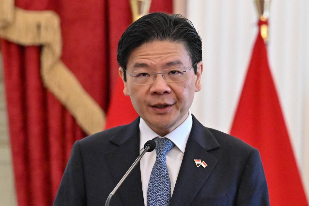 Singapore's Prime Minister Lawrence Wong gives a press statement following his meeting with Indonesia's President Prabowo Subianto at the presidential palace in Jakarta on Nov 6, 2024. - (Photo by BAY ISMOYO / AFP)