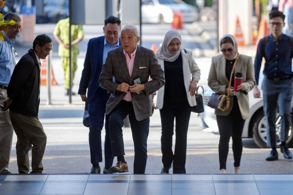 Kinabatangan MP Datuk Seri Bung Moktar Radin and his wife, Datin Seri Zizie Izette Abdul Samad at the Kuala Lumpur Courts Complex, today. - Photo by Bernama