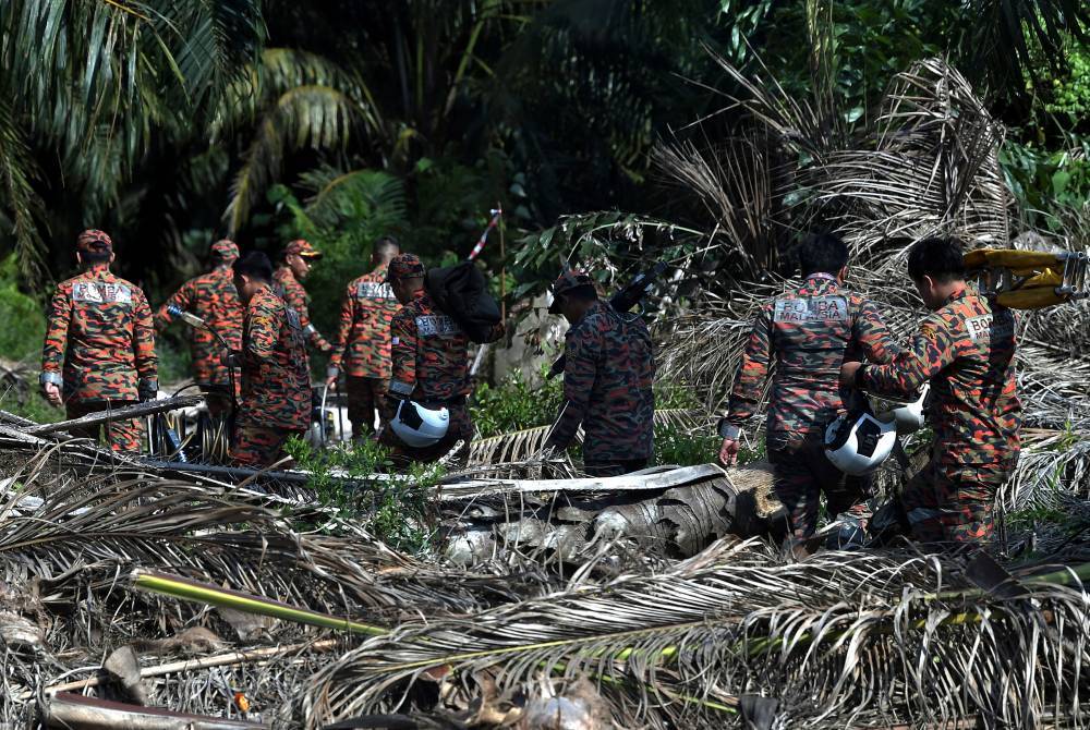 Rescue personnel at the scene of the crash Feb 13, 2024. - Photo by Bernama
