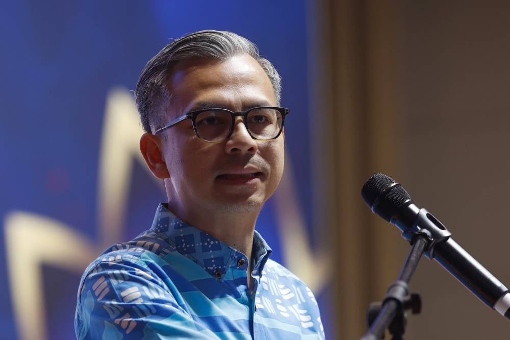 Communications Minister Fahmi Fadzil at the Aidilfitri gathering hosted by the Federal Territory PKR Leadership Council at Wisma TKC, yesterday. - Photo by Bernama 