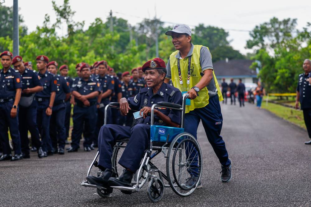Confined to a wheelchair, Mahamat was assisted by Election Commission (EC) personnel and completed the voting process by 8.50 am. - Bernama photo