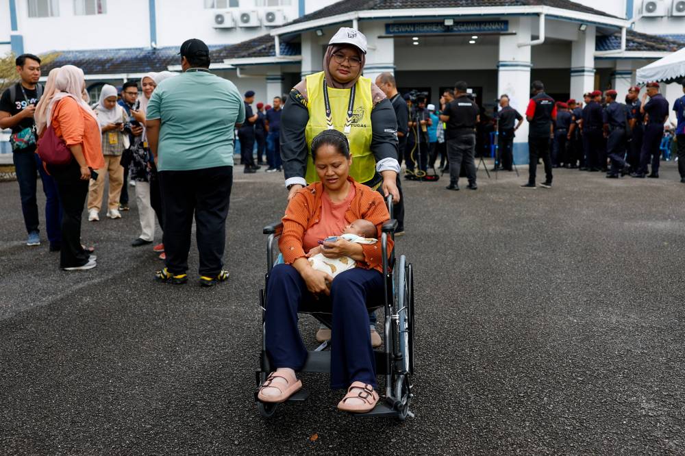 Surya Mat, a 40-year-old housewife, said she started preparing at 7am before her husband accompanied her to the polling station. - Bernama photo