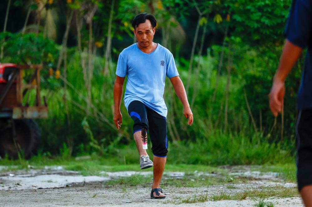 A group of youths in the Ayer Kuning constituency showcase their skills in playing the traditional game of sepak bulu ayam, which is gradually fading from the memory of the younger generation. Photo by Bernama