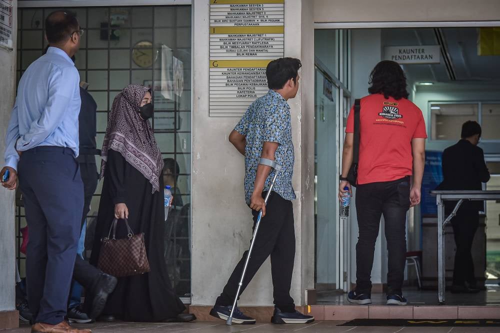 Zayn Rayyan Abdul Matin's parents, Zaim Ikhwan Zahari and Ismanira Abdul Manaf at the Petaling Jaya Courts Complex, for their trial. - Photo by Bernama