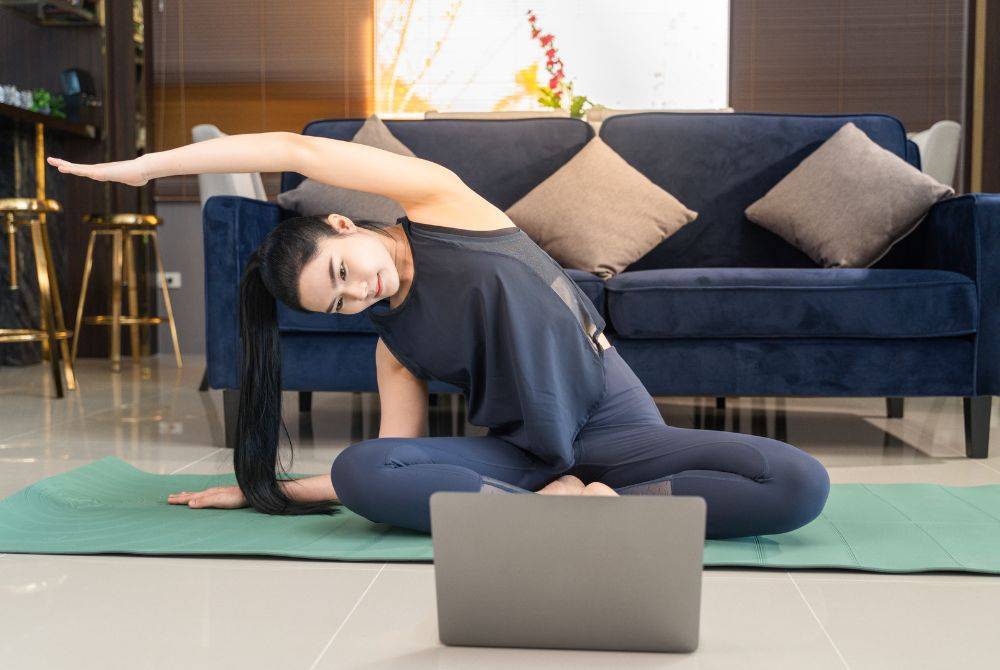 With hectic schedules and the rise of remote lifestyles, many are turning to digital Pilates to stay consistent in their fitness routines. Photo illustrated by Sinar Daily.