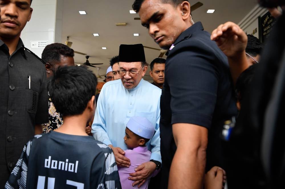 Prime Minister Datuk Seri Anwar Ibrahim (centre) mingles with guests during lunch at Kedai Papan Restaurant in Bandar Saujana Putra before performing Friday prayers today. Photo by Bernama