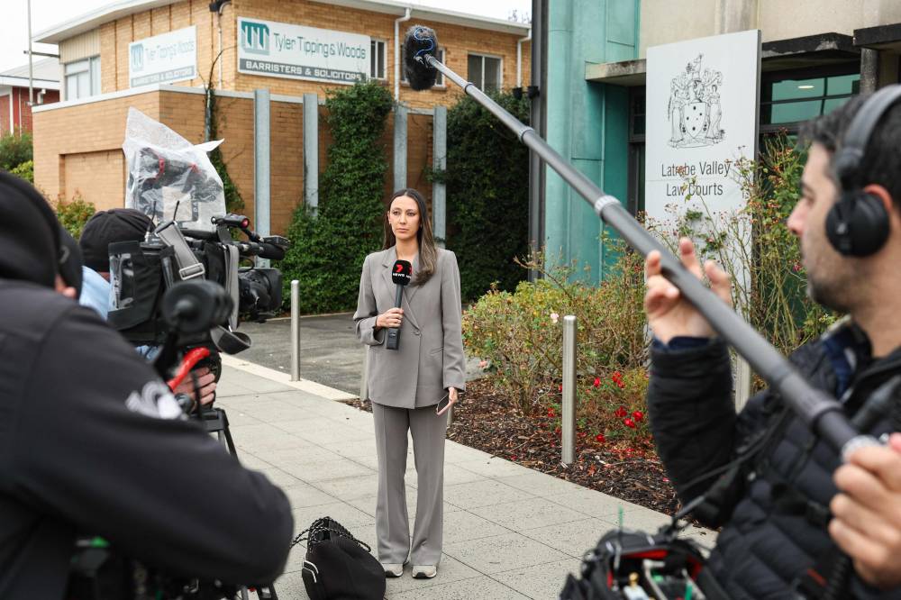 Media personnel are seen outsides the Latrobe Valley Magistrates' Court building in Morwell, where an Australian woman accused of murdering three people with a toxic mushroom-laced beef Wellington faces trial on April 30, 2025 in a case that has grabbed global attention. (Photo by Martin KEEP/AFP)