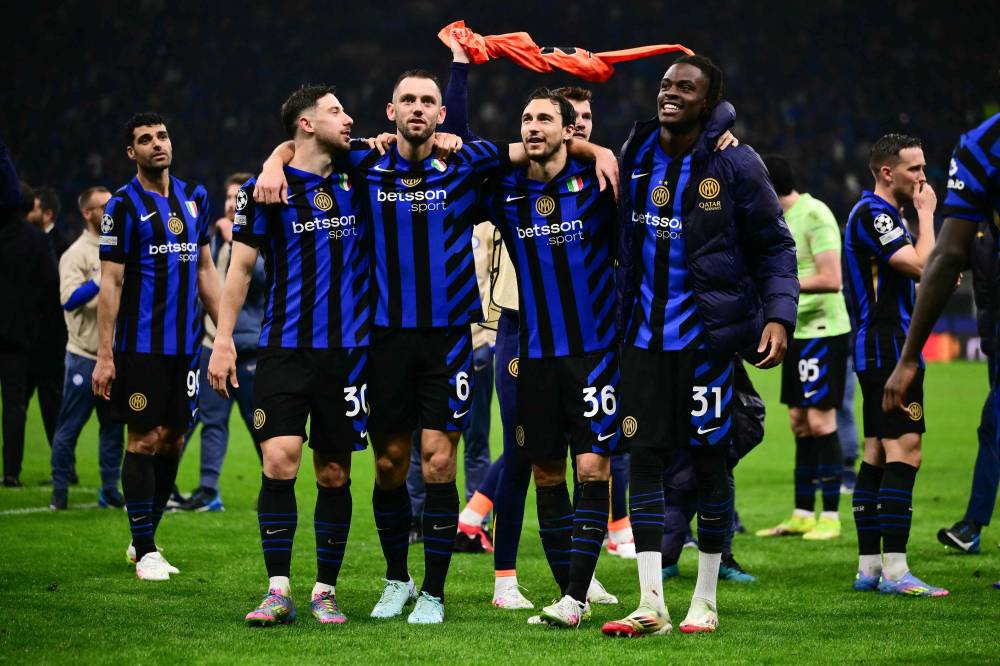(From L) Inter Milan's Brazilian defender #30 Carlos Augusto, Inter Milan's Dutch defender #06 Stefan de Vrij, Inter Milan's Italian defender #36 Matteo Darmian and Inter Milan's German defender #31 Yann-Aurel Bisseck celebrate after Inter Milan won the UEFA Champions League semi-final second leg football match between Inter Milan and FC Barcelona at the San Siro stadium in Milan on May 6, 2025. (Photo by Marco BERTORELLO / AFP)