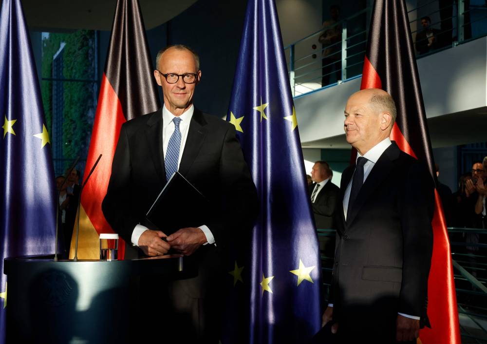 Newly elected German Chancellor Friedrich Merz (L) and his predecessor Olaf Scholz attend a handover ceremony at the Chancellery in Berlin on May 6, 2025. (Photo by Odd ANDERSEN / AFP)